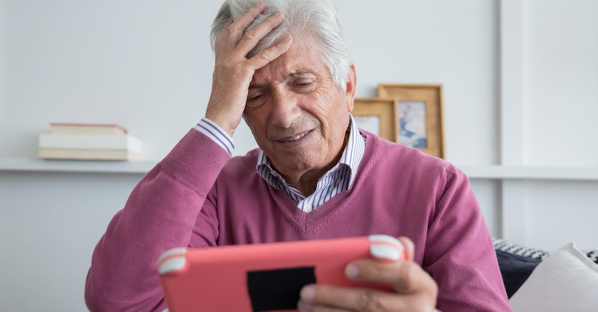 How to avoid becoming stressed while playing endurance games? [closed] - An Elderly Man Holding his Forehead While Holding the Pink Nintendo Switch