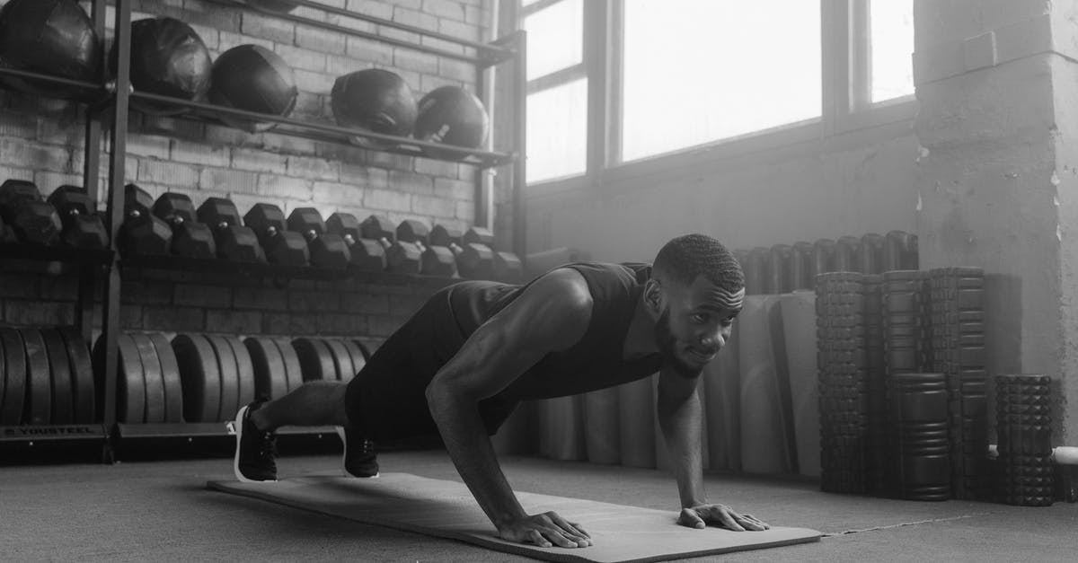 How to avoid leveling up while training - A Grayscale Photo of a Man Doing Push Ups