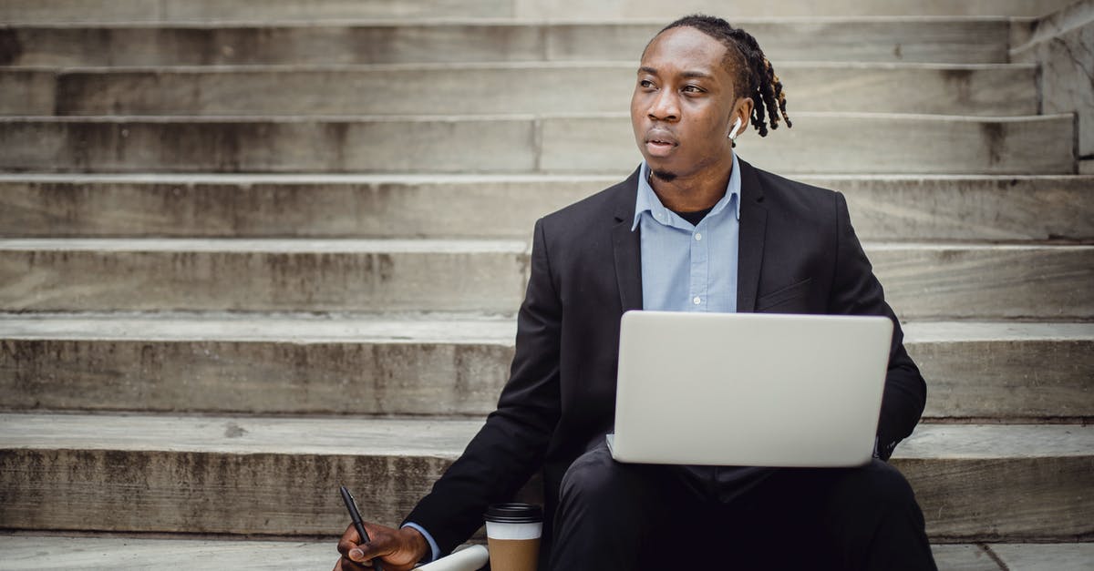 how to avoid white in the distance after alt + tab - Thoughtful black worker using netbook and taking notes sitting on steps how to avoid white in the distance after alt + tab - Thoughtful black worker using netbook and taking notes sitting on steps