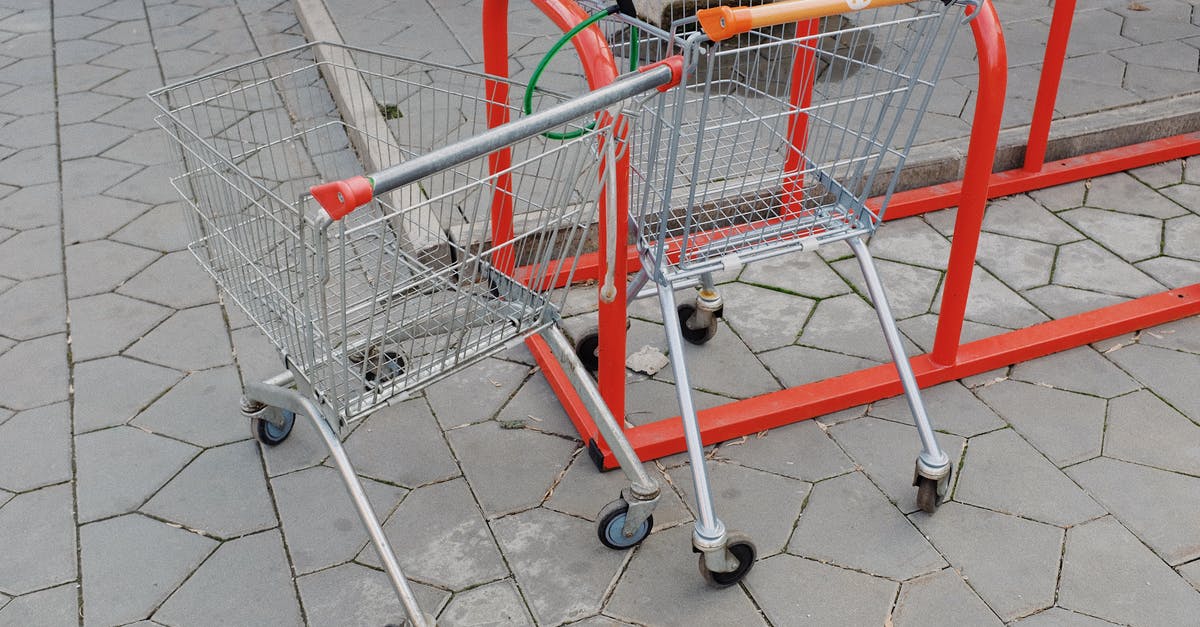 How to batch sell equipments? - Shopping trolleys attached to metal stand near supermarket on street How to batch sell equipments? - Shopping trolleys attached to metal stand near supermarket on street