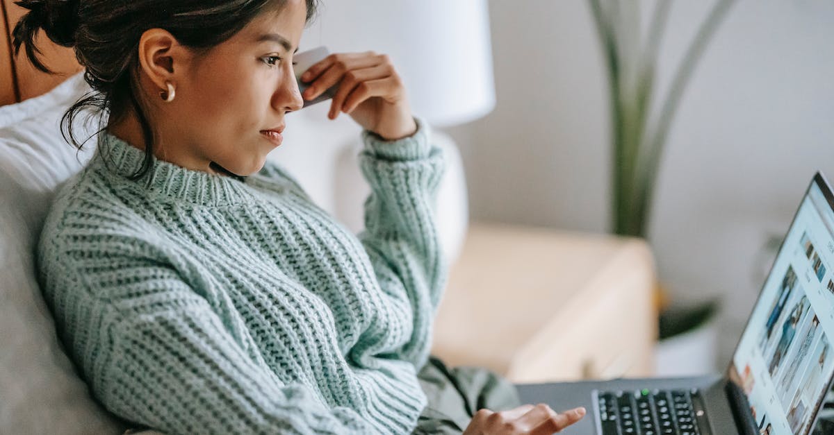 How to buy Benefactor Schafter - Side view of crop concentrated young ethnic female using touchpad of netbook and shopping online