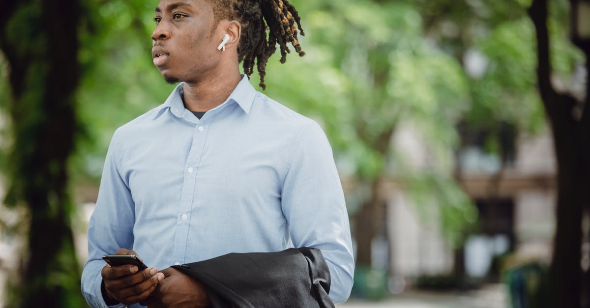 How to call emergency meeting on the Submerged map? - Stylish black businessman in TWS earbuds with smartphone waiting for meeting in park How to call emergency meeting on the Submerged map? - Stylish black businessman in TWS earbuds with smartphone waiting for meeting in park