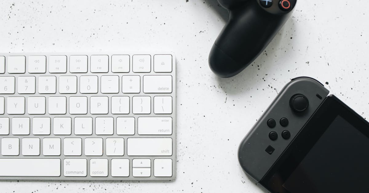 How to change control scheme on Lego Games - White Computer Keyboard on Marble Surface