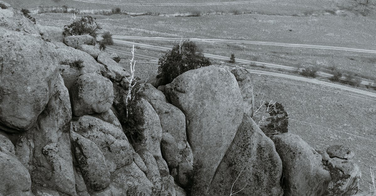 How to change direction of boulder - Boulders against narrow roads in mountains in daytime