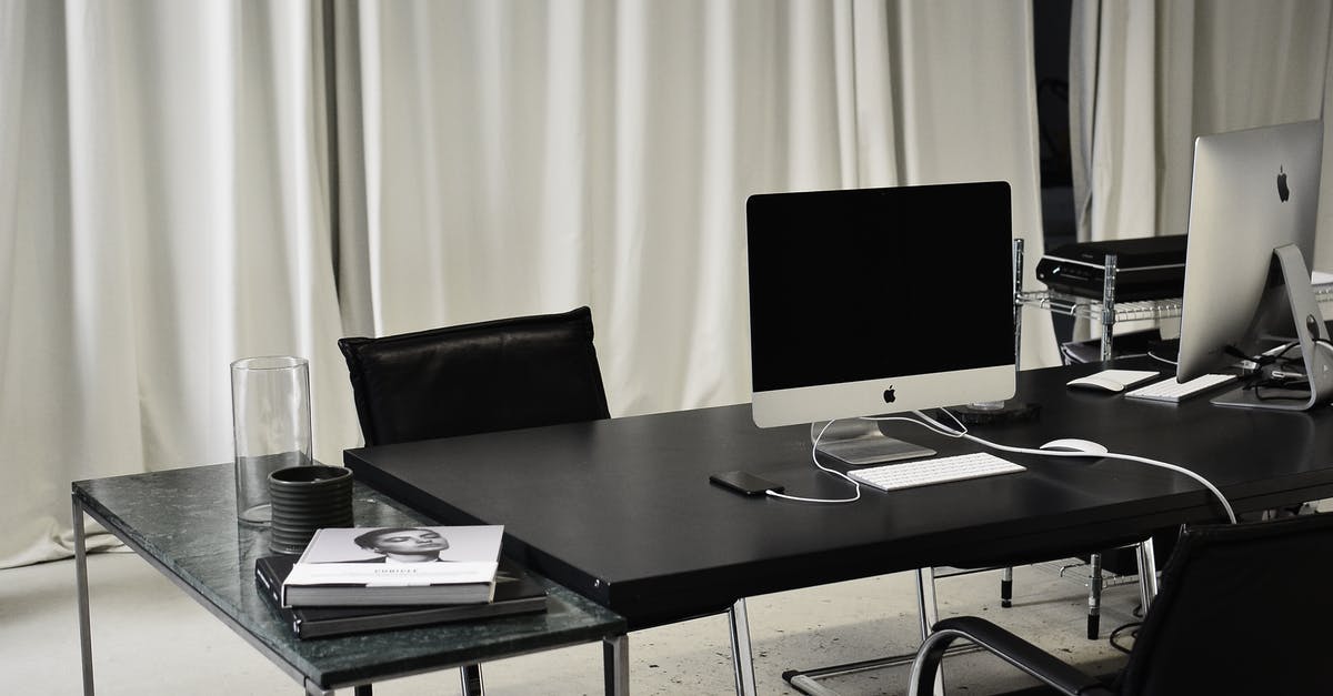How to charge a Sony PS3 wireless keypad with a PC? - Black and white of workspace of office with computers placed on table with wireless mouse and keyboard near smartphone How to charge a Sony PS3 wireless keypad with a PC? - Black and white of workspace of office with computers placed on table with wireless mouse and keyboard near smartphone