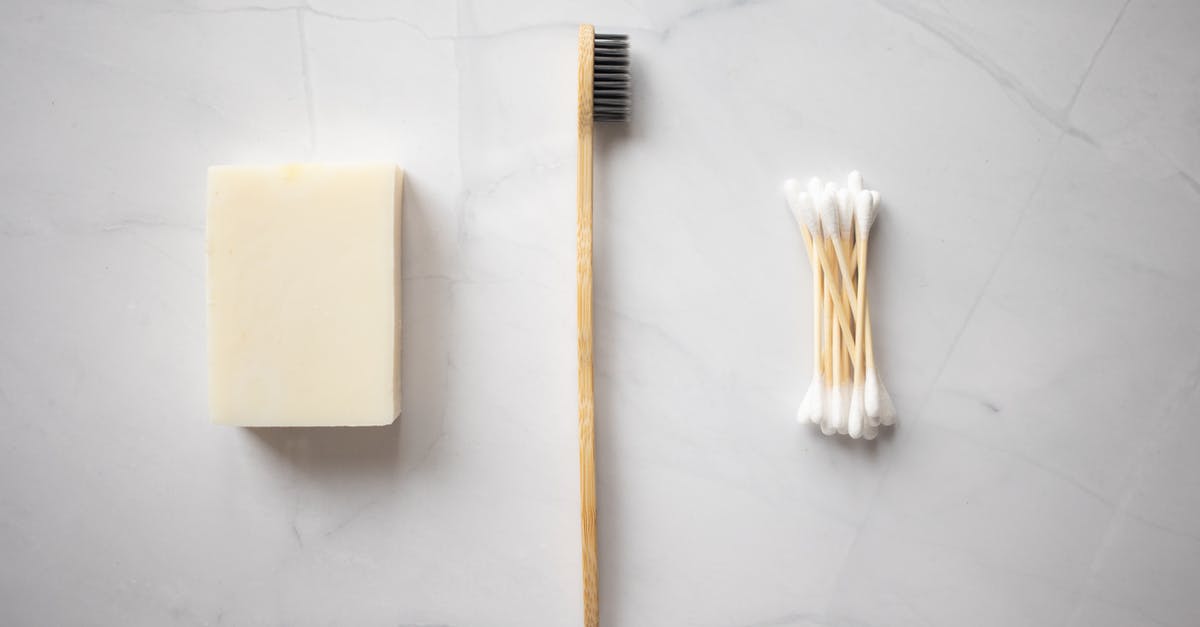 How to clean corrosion from PSP analog stick connector? - From above of bamboo toothbrush placed between organic soap and wooden ear sticks placed on marble table How to clean corrosion from PSP analog stick connector? - From above of bamboo toothbrush placed between organic soap and wooden ear sticks placed on marble table