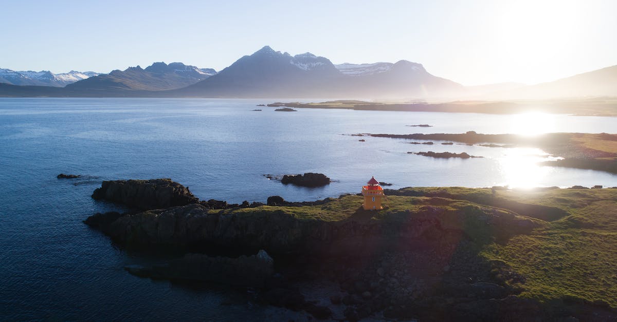 How to clear the lighthouse? - Bay coast with small lighthouse at sunrise How to clear the lighthouse? - Bay coast with small lighthouse at sunrise