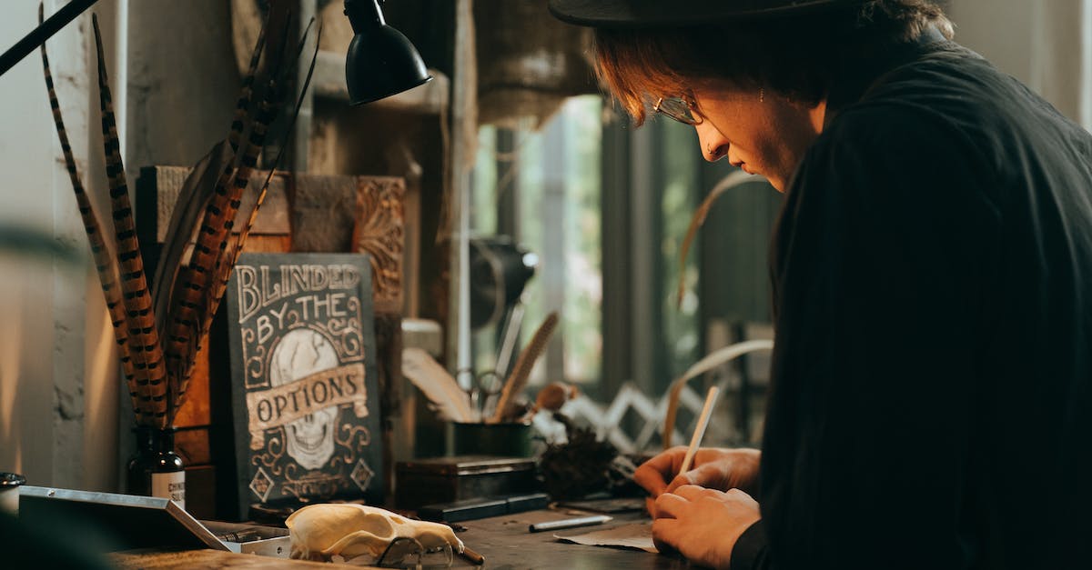 How to completely unlock a hat objective? - Man in Black Long Sleeve Shirt and Black Hat Slicing Meat on Brown Wooden Table