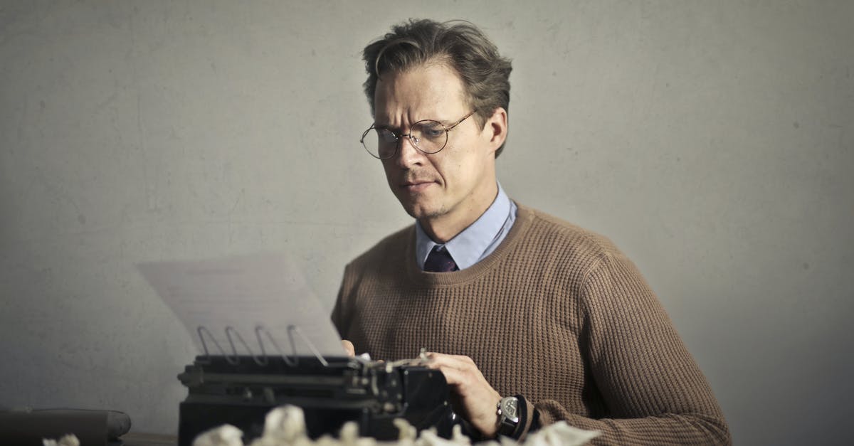 How to copy a main level to editor - Adult frowned male writer working on typewriter at home