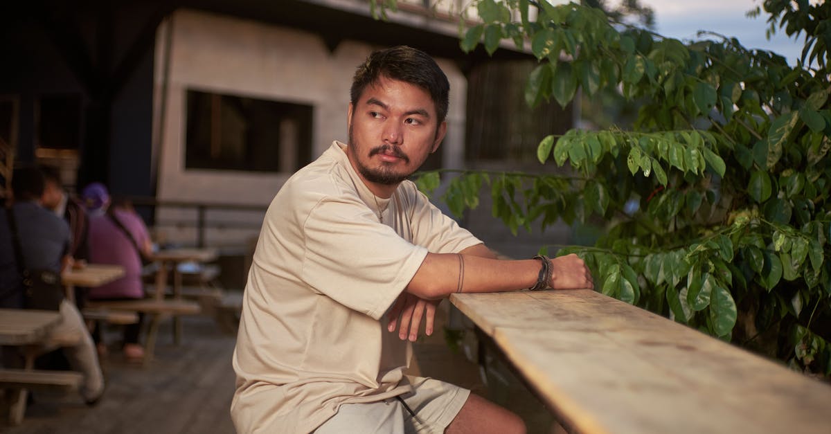 How to Counter Juggernauts? - Man in Beige Long Sleeve Shirt Sitting on Brown Wooden Bench