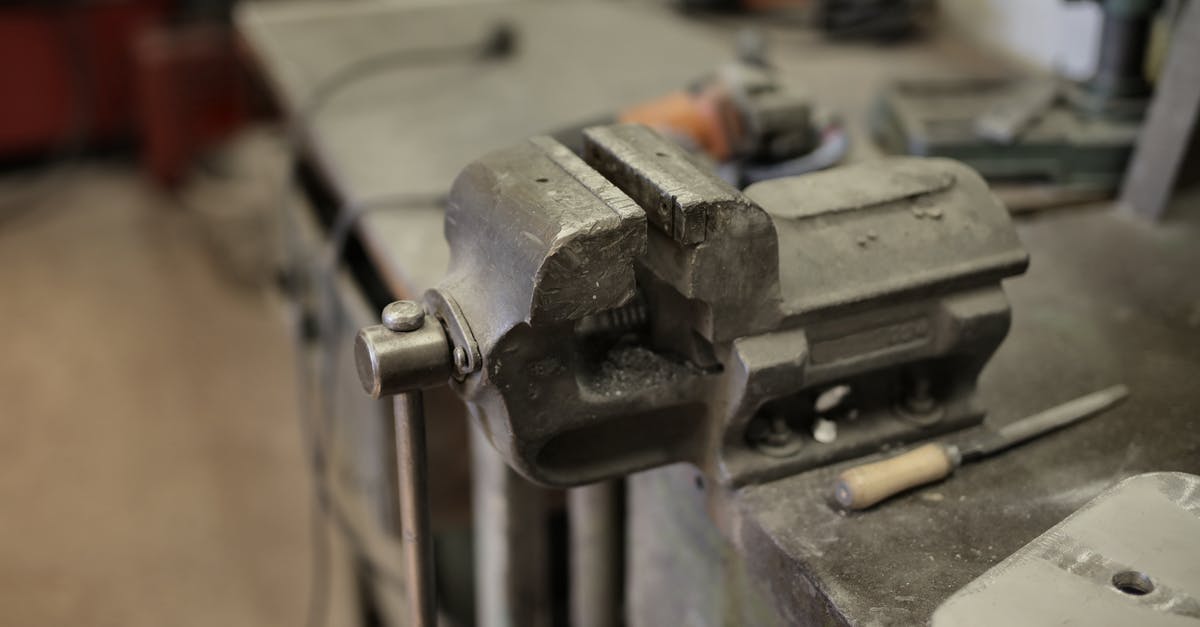 How to create an NBT file for a spawner in minecraft? - From above of vise fixing at workbench among different tools in workshop