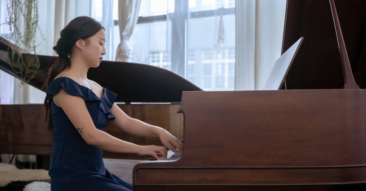 How to create an "Effect Aura" for players? - Focused Asian woman in elegant dress playing piano