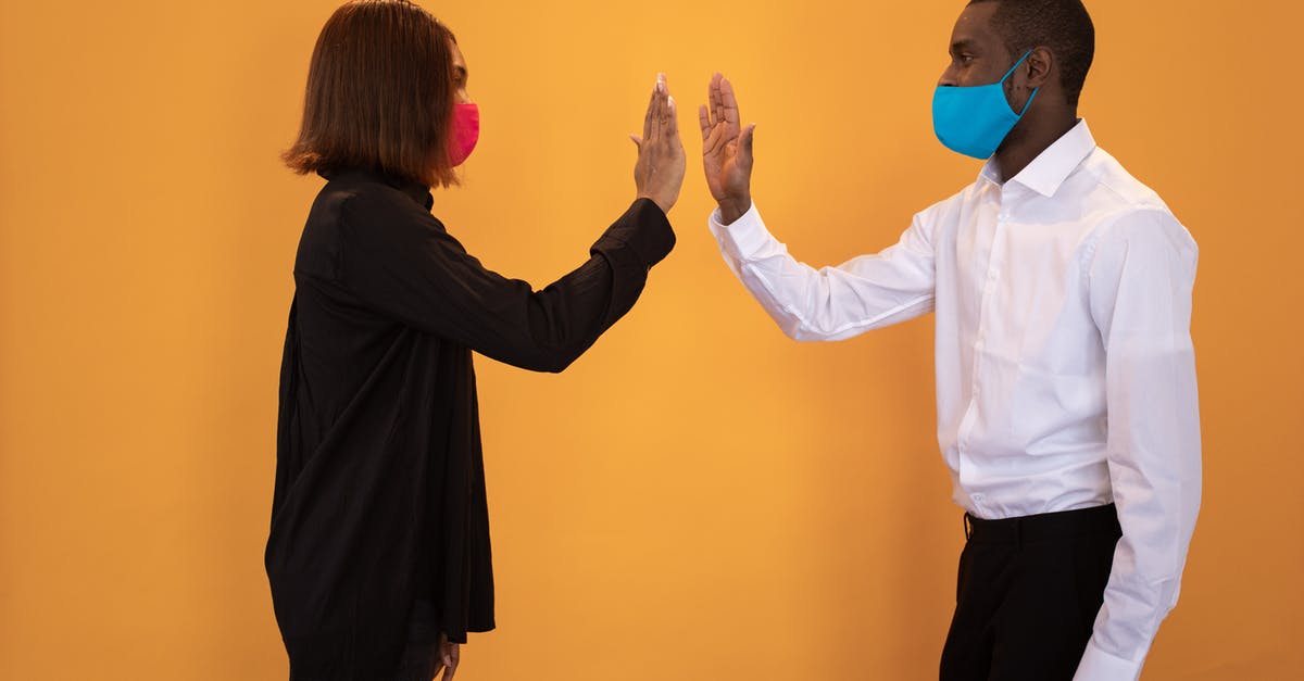 How to deal with Necro (zombie) virus in Plaugue inc - Black couple in masks giving high five in studio