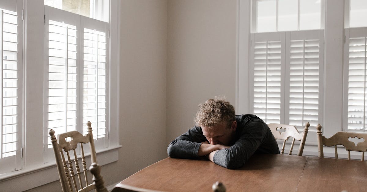 How to defeat Stalker solo? - Man in Gray Long Sleeve Shirt Sitting on Brown Wooden Chair