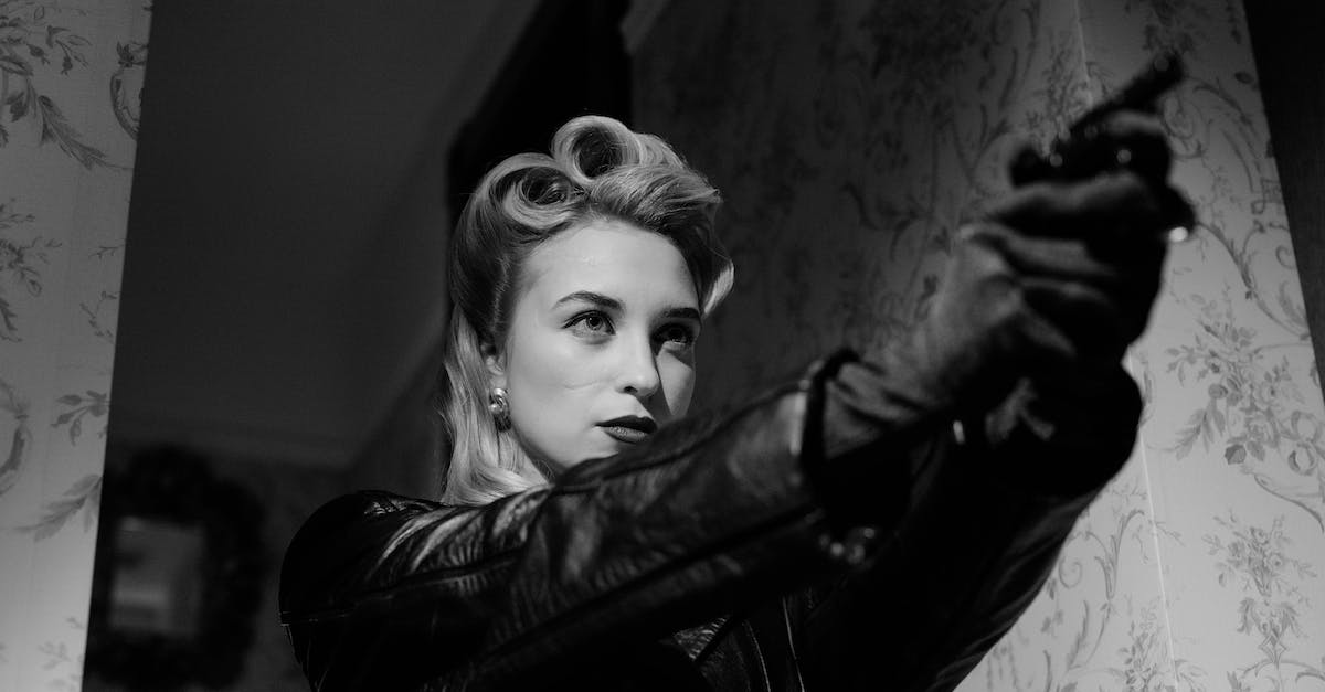How to detect smugglers? - Blonde Woman In Black Leather Coat Pointing A Gun