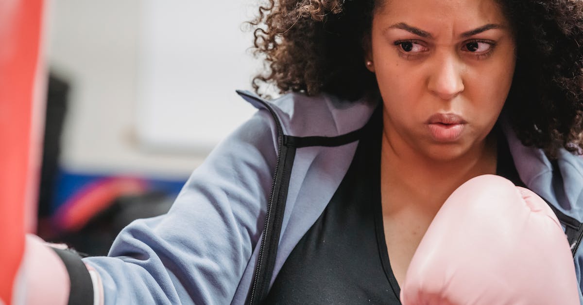 How to determine whether Attack or Strength will train faster? - Crop plump African American woman in boxing gloves doing hit of punching bag during hard training in gym How to determine whether Attack or Strength will train faster? - Crop plump African American woman in boxing gloves doing hit of punching bag during hard training in gym