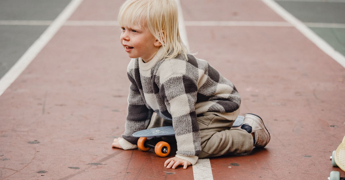 How to disable play time tracking? - Full body side view of playful little kid with penny board sitting on red track of sports ground on blurred background