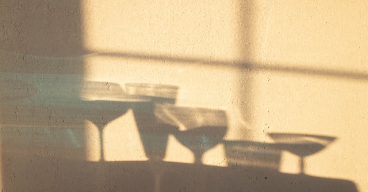How to do a full diplomatic integration of a vassal? - Shadows of different crystal glasses filled with drinks reflecting on white wall in sunlight