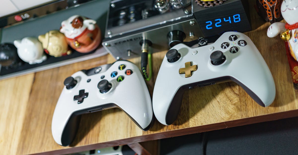 How to download and play xbox games offline - White Xbox One Controllers on Table