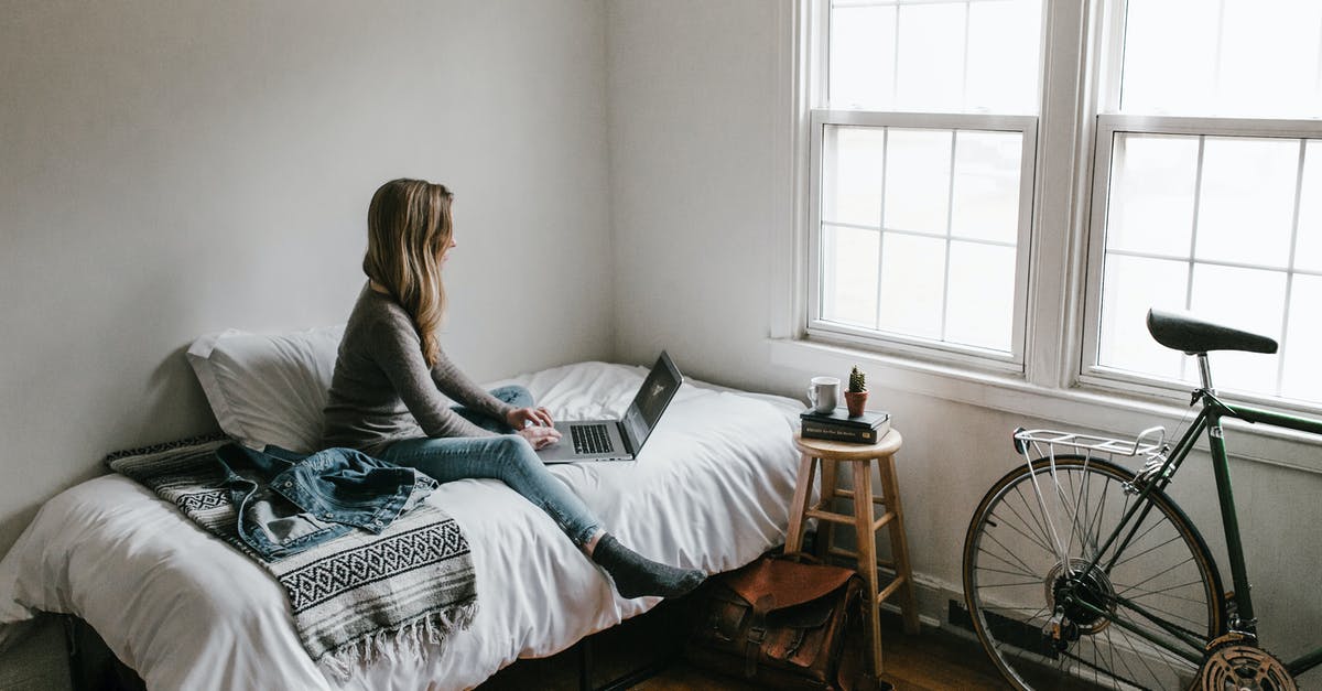 How to download Windows games from Steam onto a Linux computer? - Woman in Gray Shirt Sitting on Bed