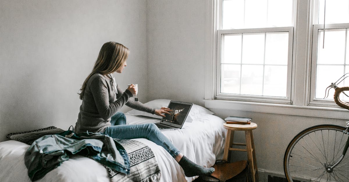 How to download Windows games from Steam onto a Linux computer? - Woman in Gray Long Sleeve Shirt Sitting on Bed Reading Book