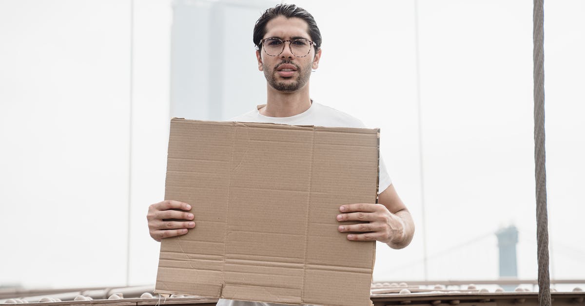 How to enable the bribing of democracies - Man Holding a Blank Placard