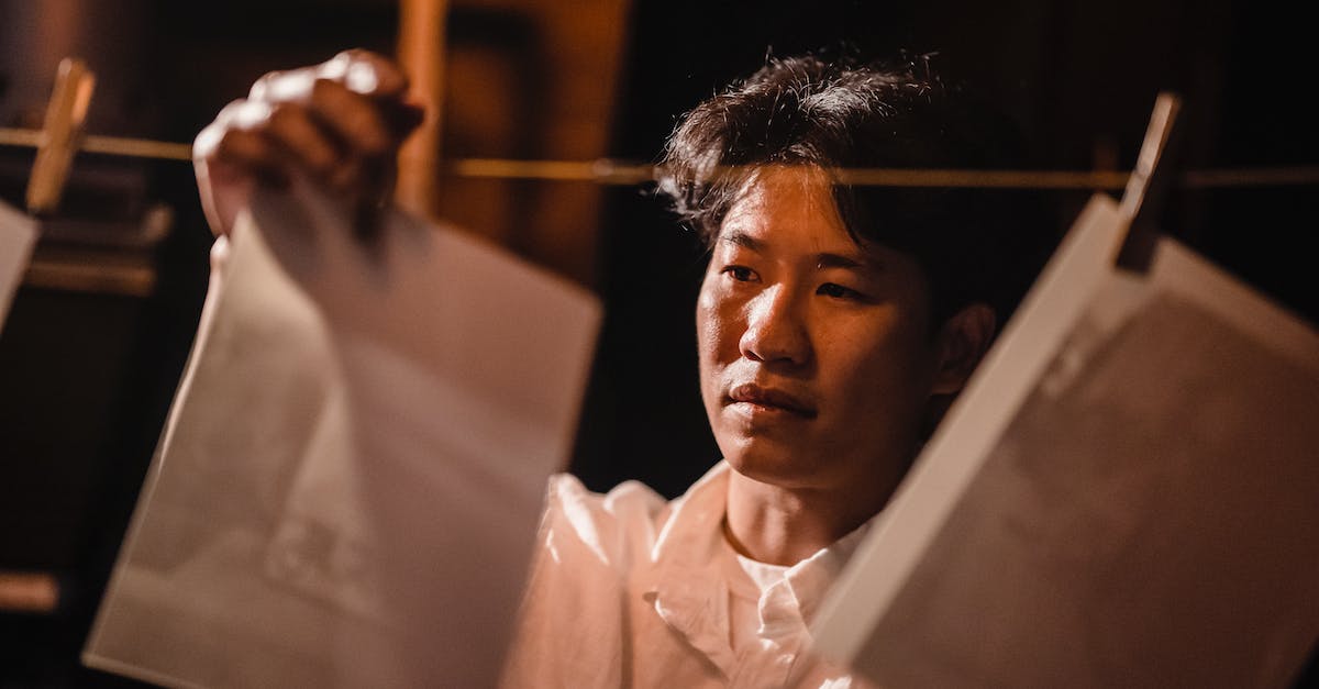 How to enter photo mode? - Man in White Dress Shirt Holding White Paper How to enter photo mode? - Man in White Dress Shirt Holding White Paper