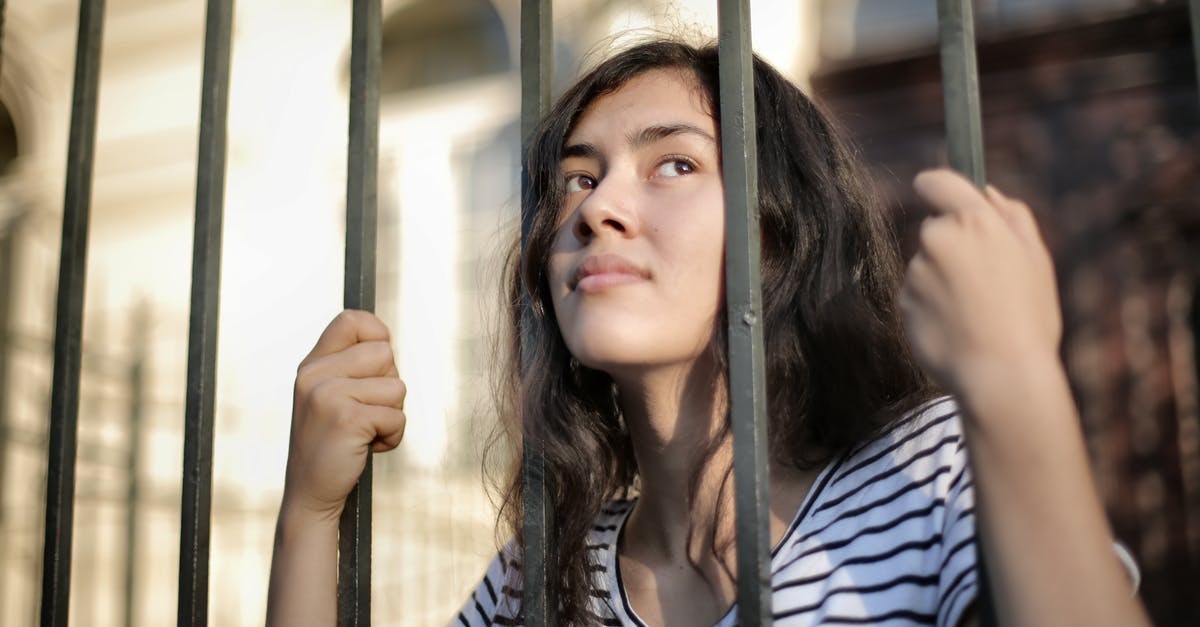 How to escape from the Stronghold of the Master Assassin? - Sad isolated young woman looking away through fence with hope