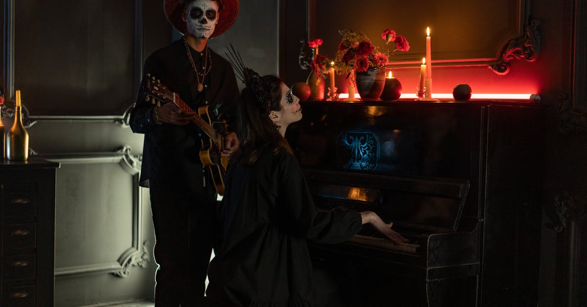 How to execute a stunned zombie in Dying Light? - Man and Woman in Halloween Costumes with Musical Instruments