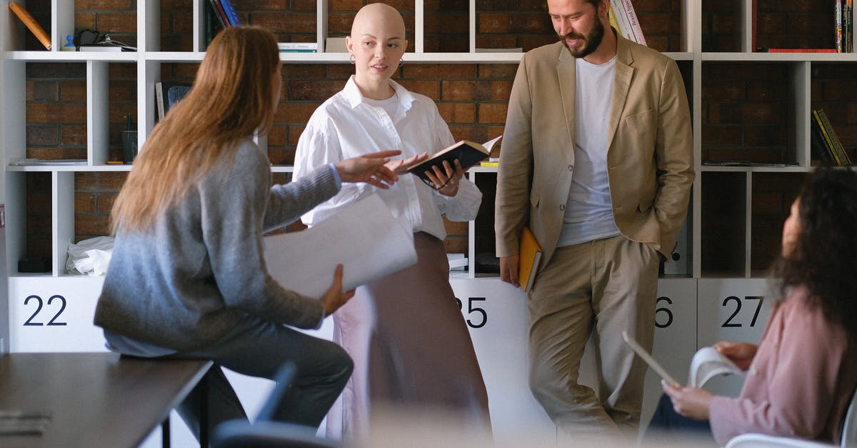 How to execute a team scoreboard? - Colleagues discussing business issues in creative workspace How to execute a team scoreboard? - Colleagues discussing business issues in creative workspace