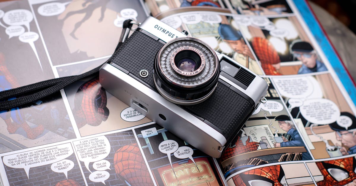 How to film from a Nintendo DSi - From above of opened comics magazine with vintage photo camera placed on top How to film from a Nintendo DSi - From above of opened comics magazine with vintage photo camera placed on top