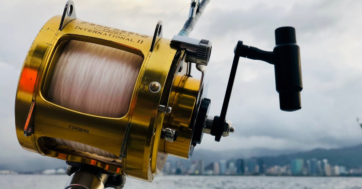 How to find fishing bait? - Selective Focus of Brown Fishing Reel How to find fishing bait? - Selective Focus of Brown Fishing Reel