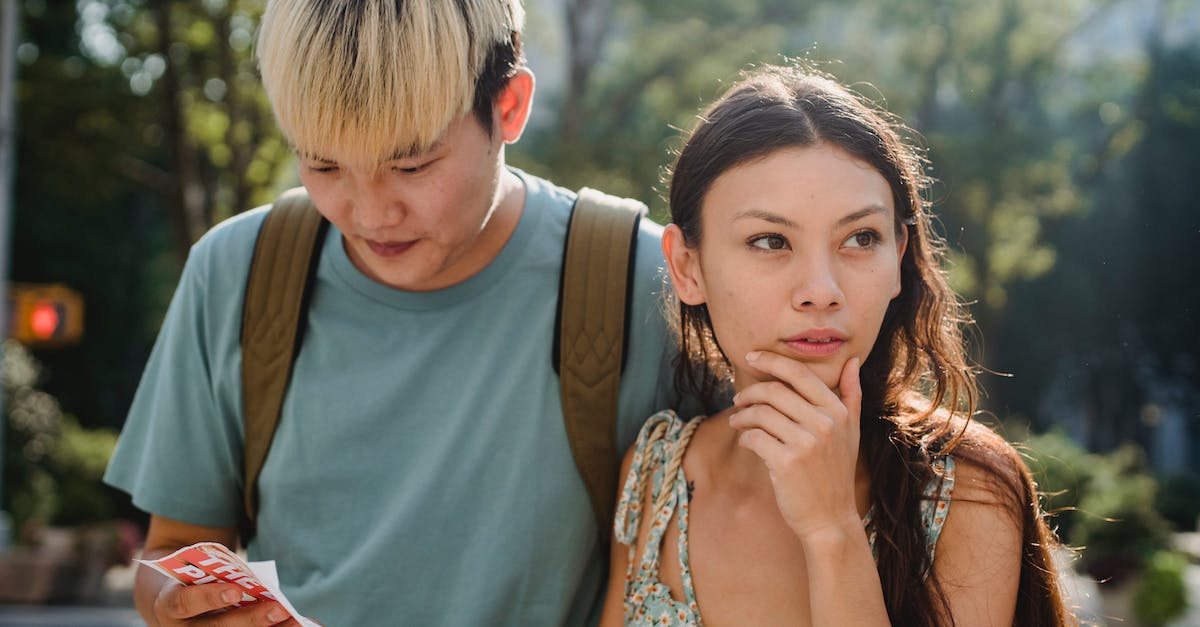 How to find villages? - Confused multiracial couple searching way in map while discovering city together during summer holidays