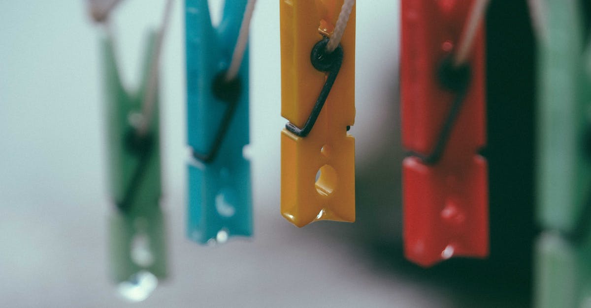 How to fix lack of green light? - Row of plastic multicolored clothes pegs hanging on holder rope against blurred background How to fix lack of green light? - Row of plastic multicolored clothes pegs hanging on holder rope against blurred background