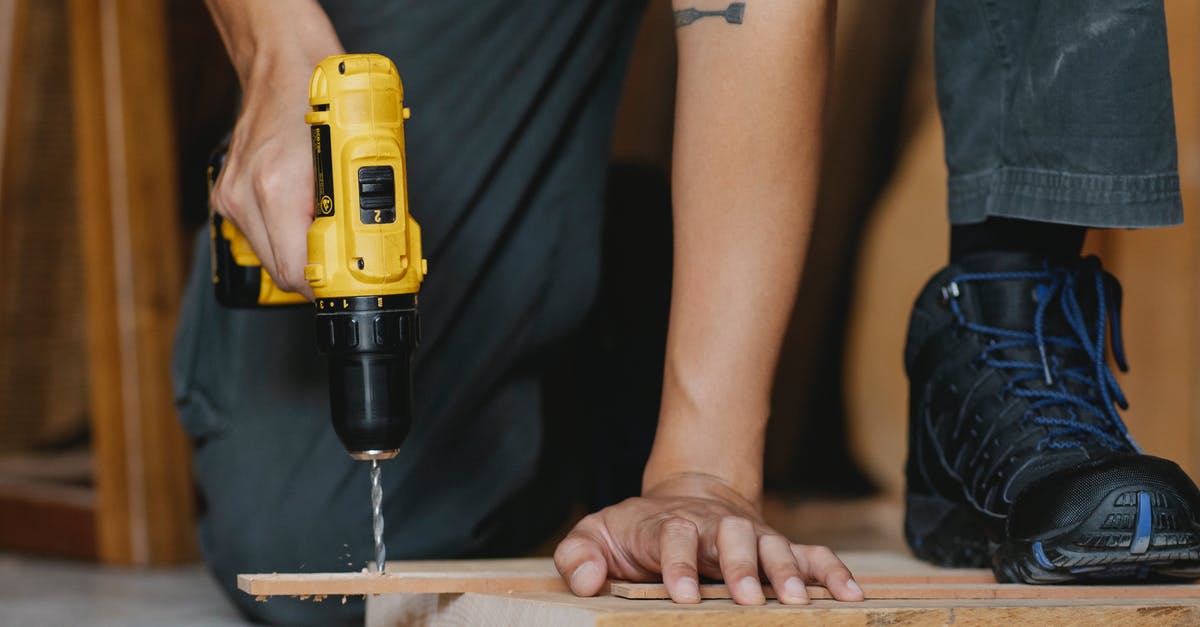 How to fix Minecraft not reacting to pressed scroll button? - Crop anonymous male drilling and pressing timber detail with foot in boot in workshop