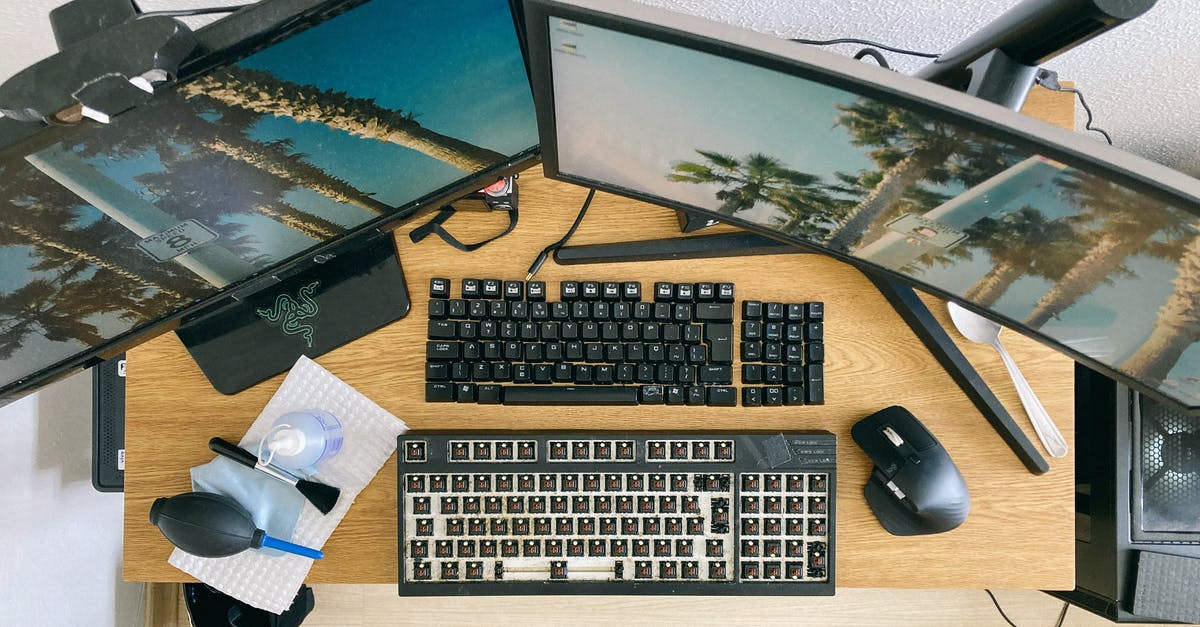 How to fix Minecraft not reacting to pressed scroll button? - From above of desktop with multi monitors and keyboard with remove keycaps for cleaning