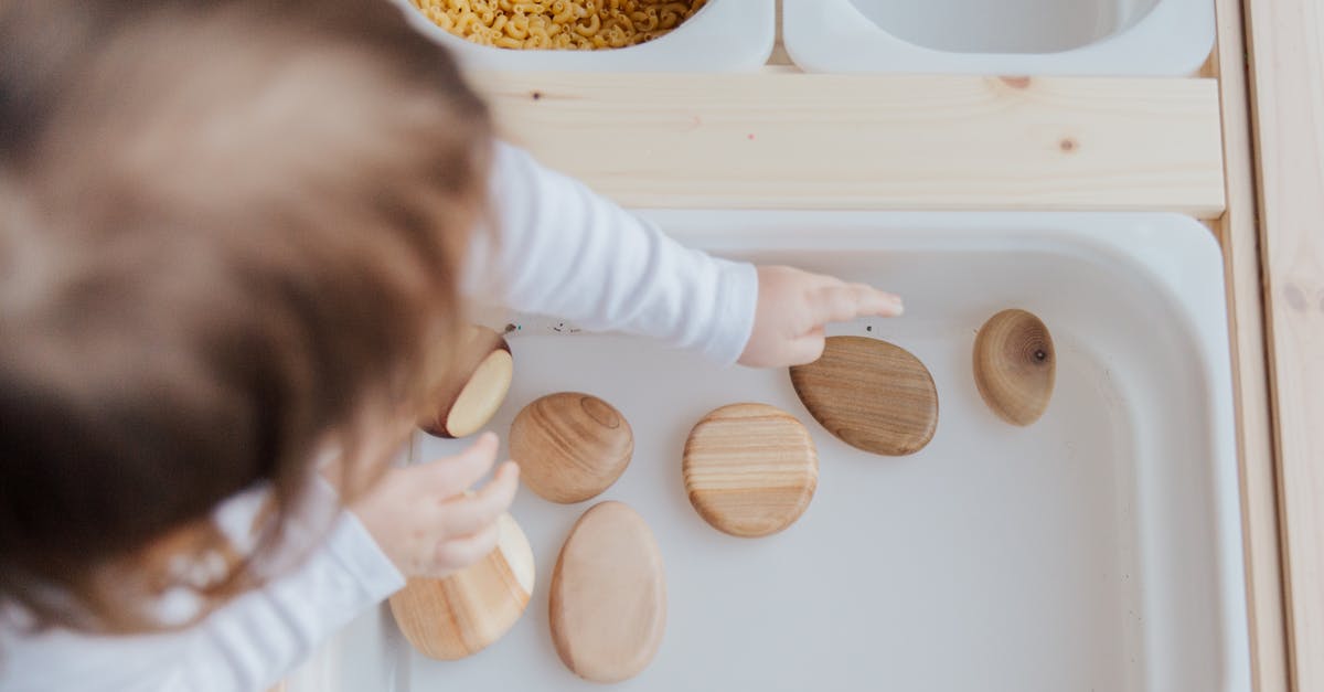 How to get a claim back? - Crop anonymous child getting brown stones from white container at home
