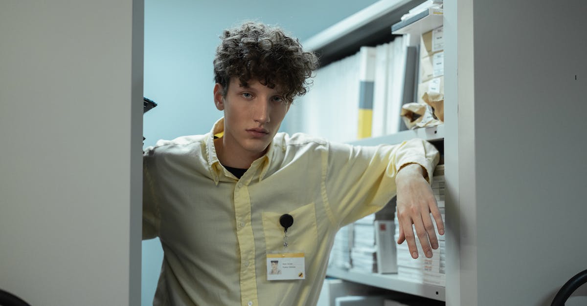 How to get a good staff - Handsome Employee leaning on a Shelf How to get a good staff - Handsome Employee leaning on a Shelf