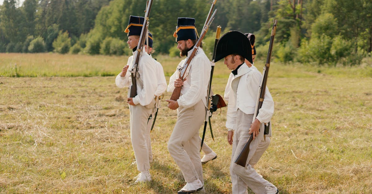 How to get a victory medal on the Teutoburg Forest historical battle? - Three Men in White Clothing and Black Vintage Hats Holding Guns While Walking on Field How to get a victory medal on the Teutoburg Forest historical battle? - Three Men in White Clothing and Black Vintage Hats Holding Guns While Walking on Field