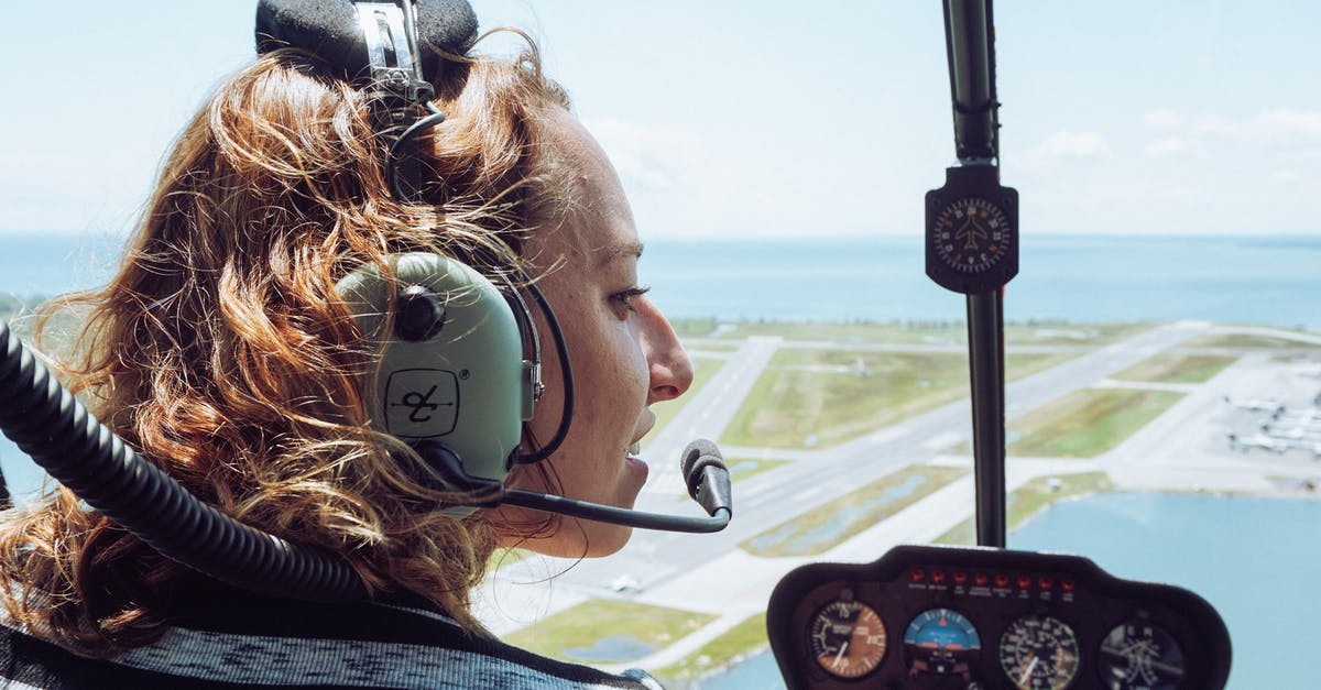 How to get female crew I failed to claim - Back view of positive young female traveler in casual wear and headset sitting in cockpit of modern helicopter during flight over coastal town How to get female crew I failed to claim - Back view of positive young female traveler in casual wear and headset sitting in cockpit of modern helicopter during flight over coastal town