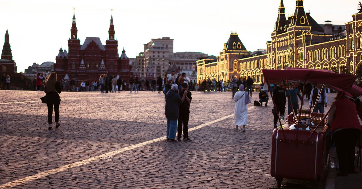 How to get into the castle with a drawbridge? - People Walking on Street Near Red Bus How to get into the castle with a drawbridge? - People Walking on Street Near Red Bus