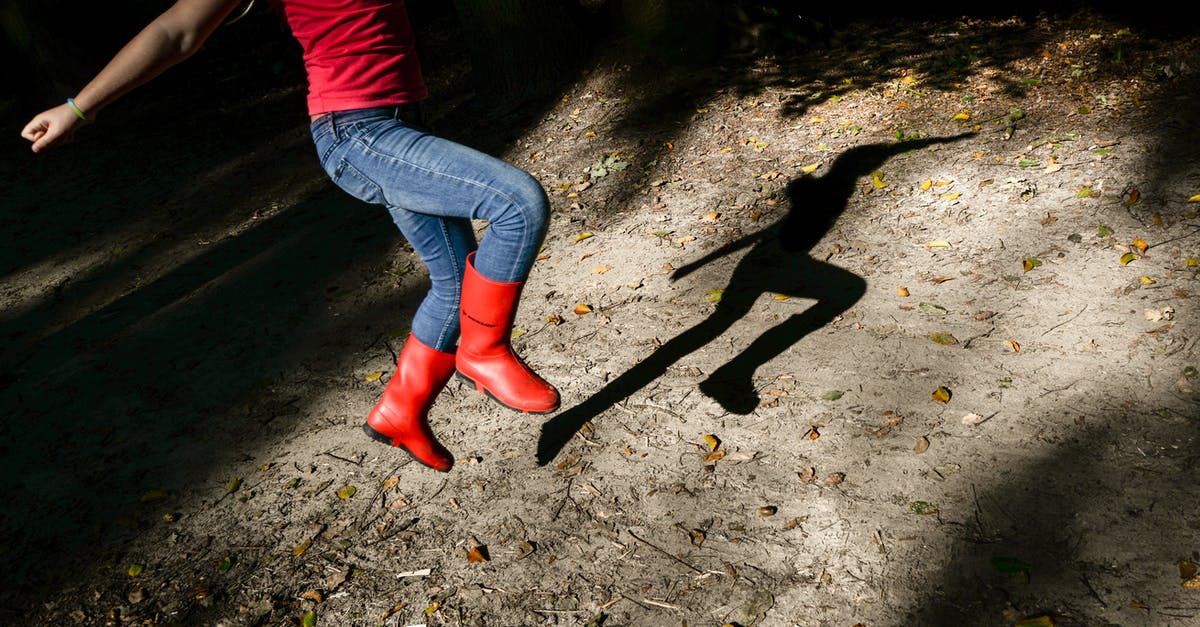How to Get Jump Boost Boots In Minecraft - Photography of a Girl in Red Shirt With Blue Denim Jeans and Red Leather Wide-calf Boots Jumping