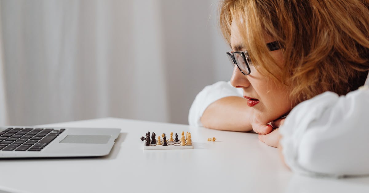 How to get mini games [closed] - Close-Up Shot of a Woman Looking at a Miniature Chess