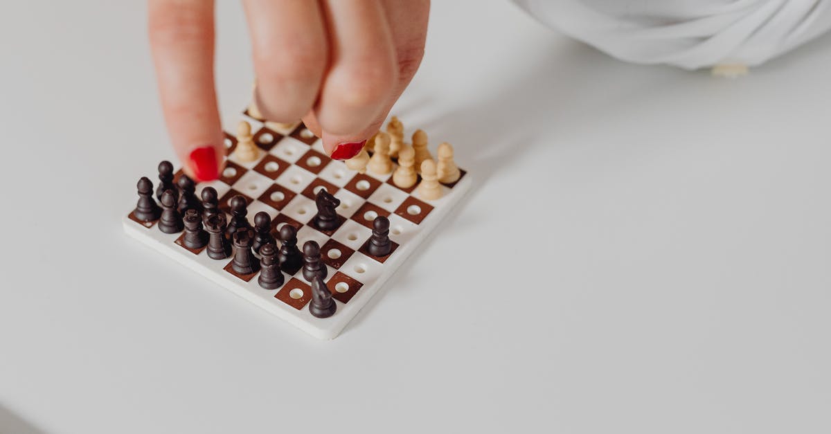 How to get mini games [closed] - Person Playing a Mini Chess on White Surface