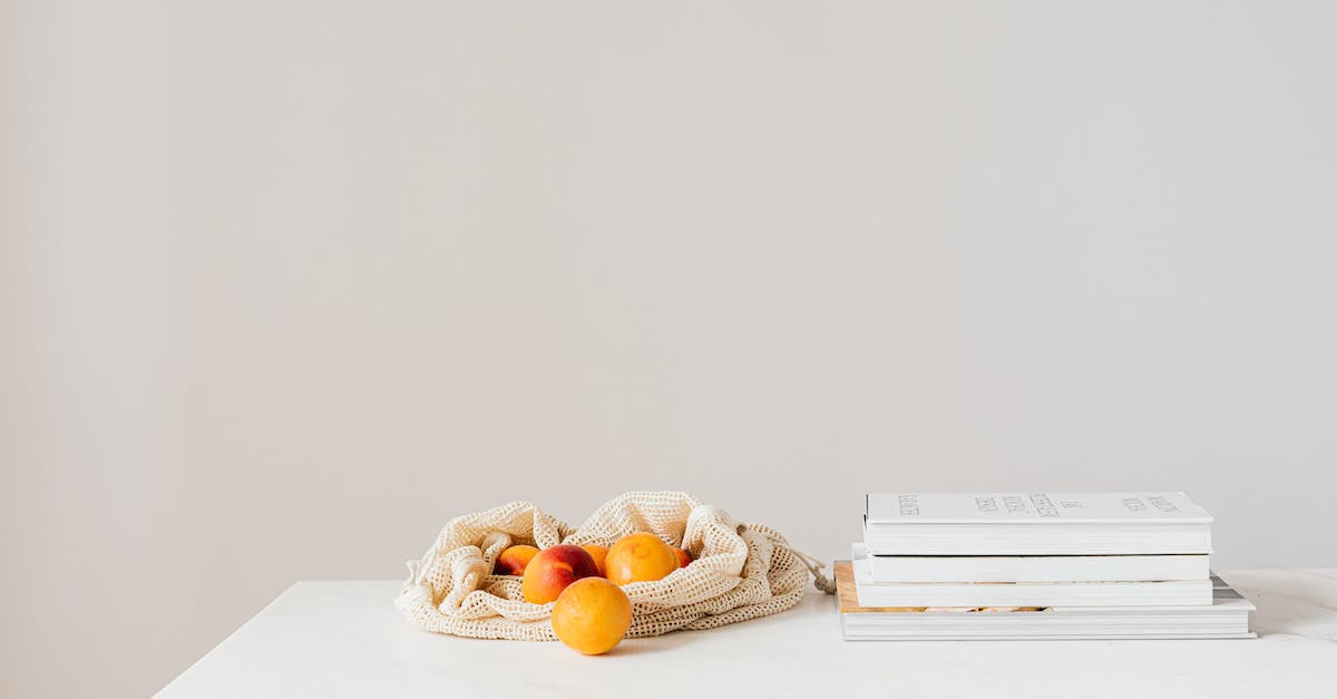 How to get Season Only achievements "Lore Books" in Diablo III? - Jute sack with natural ripe apricots on white table composed with stack of various books and magazines