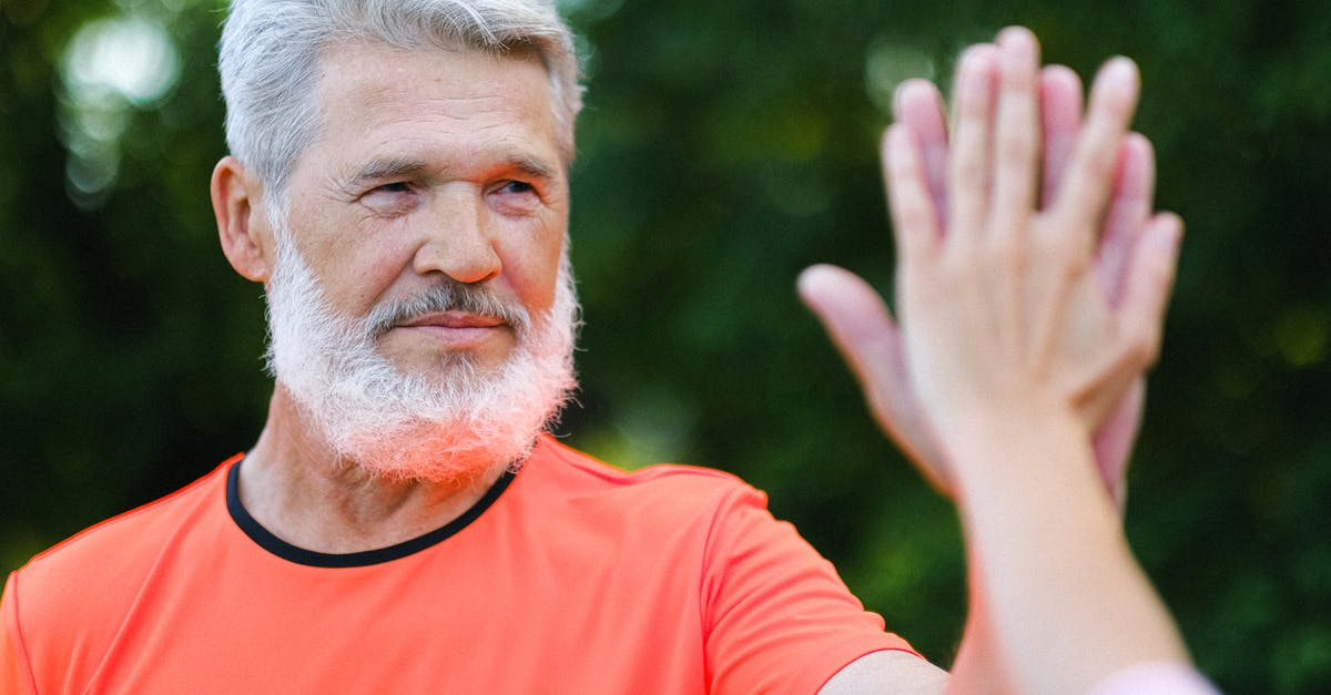 How to give potion effects to everyone on a certain team - Pensive aged man giving high five to friend