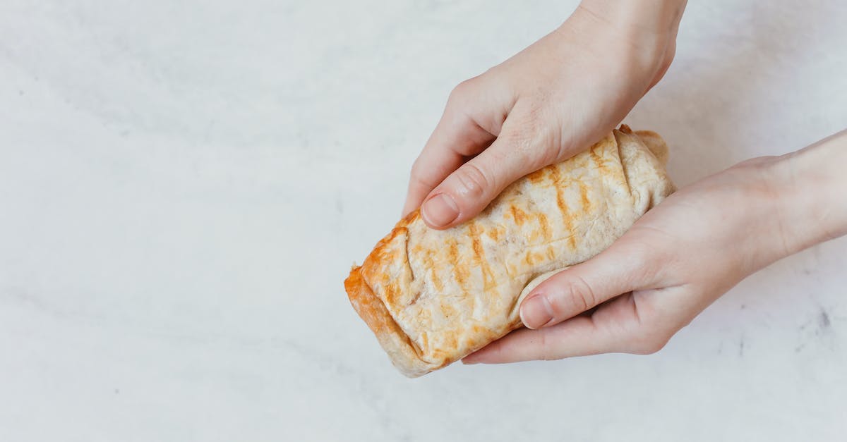 How to give wheat to a hungry follower? - Person Holding Brown Bread on White Table