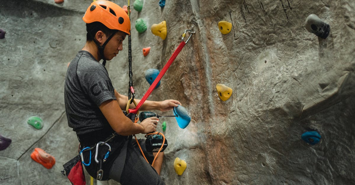 How to improve at low 6 digit rank (~200-100k)? - From below of side view of Asian male specialist in helmet drilling hole in blue climbing hold while hanging on safety rope near bouldering wall How to improve at low 6 digit rank (~200-100k)? - From below of side view of Asian male specialist in helmet drilling hole in blue climbing hold while hanging on safety rope near bouldering wall