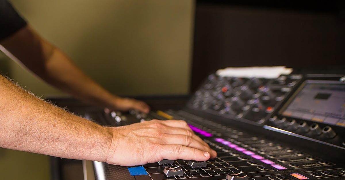 How to improve audio performance on high end gaming pc? [closed] - Close-up Of A Person's Hands on Audio Mixer