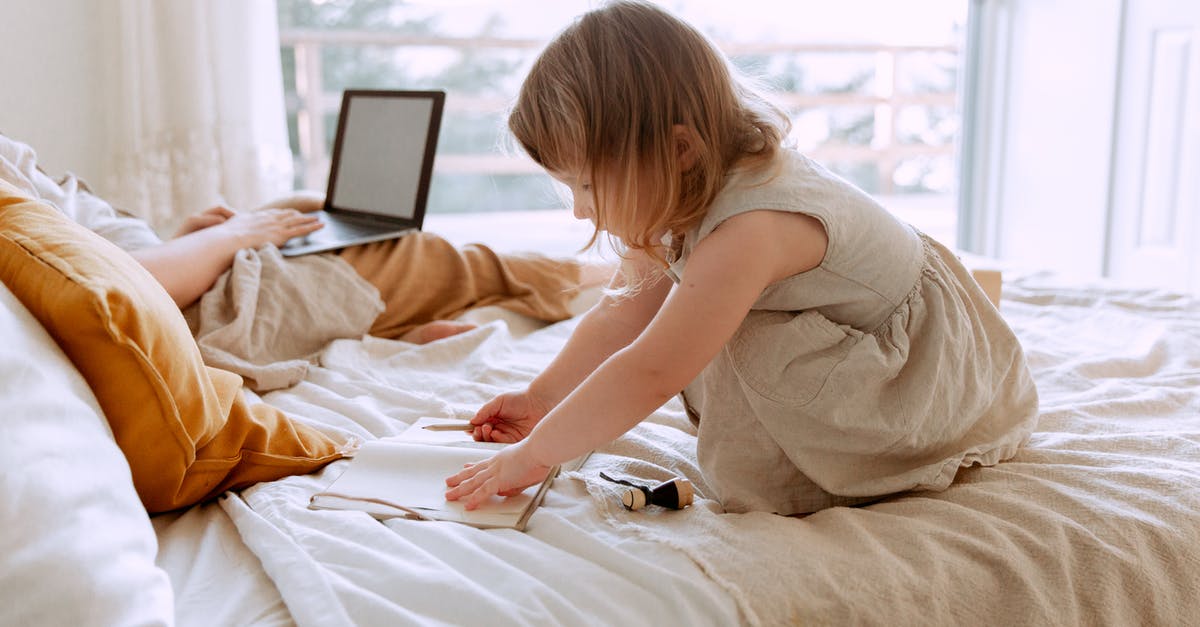 How to increase the draw distance in the Bethesda (Gamebryo engine) Fallout games? - Side view of charming girl drawing in notebook while sitting on bed with crop mother freelancer using laptop